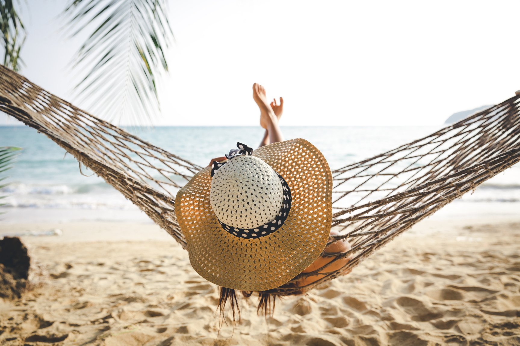 Happy woman relaxing in hammock